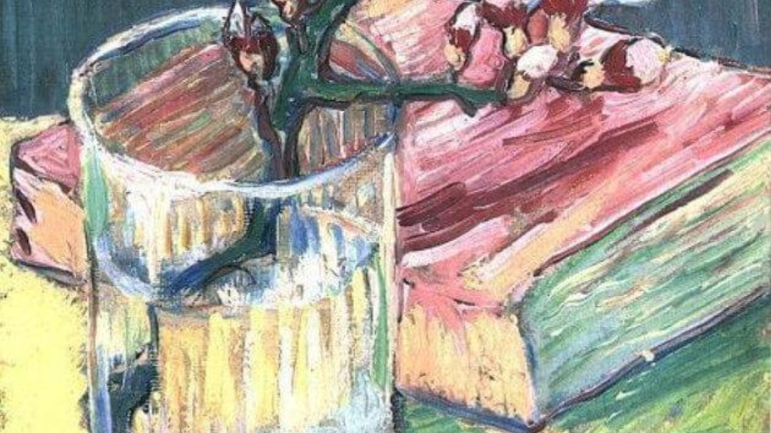 Blossoming almond branch in a glass with a book